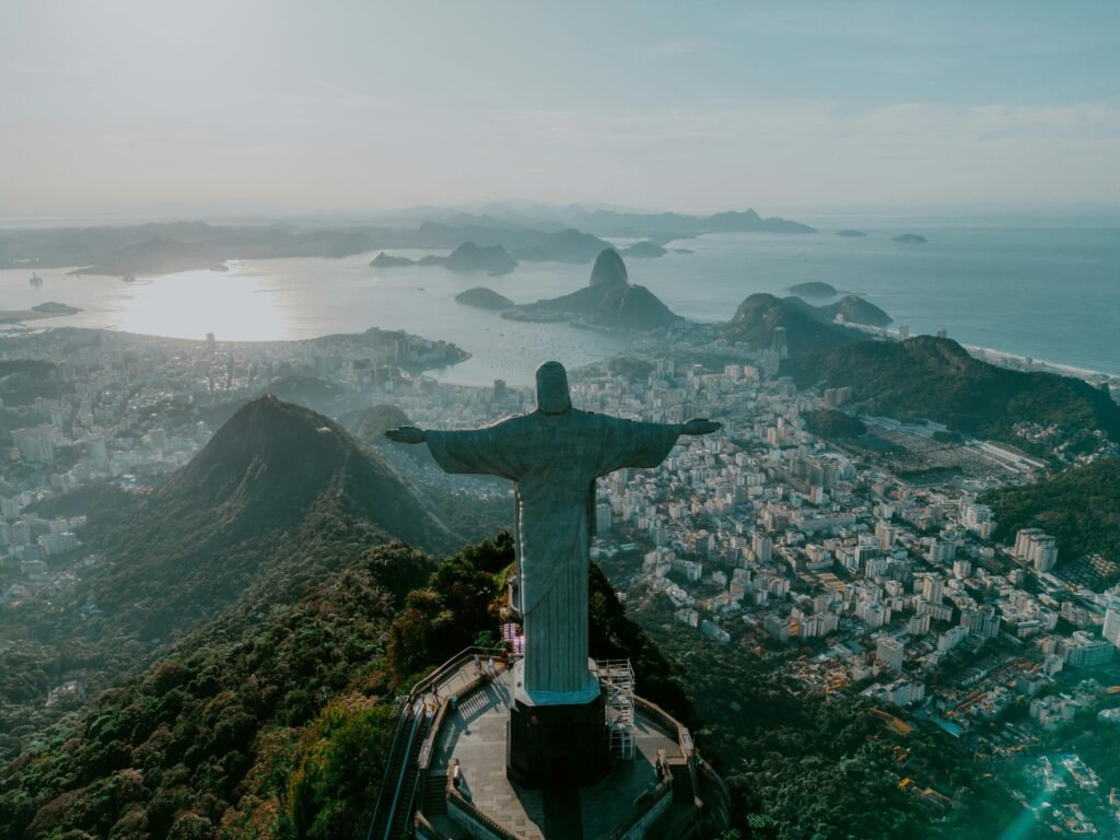 The Christ the Redeemer statue overlooking Rio de Janeiro with the city skyline and ocean in the background.