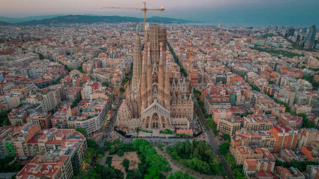 Stunning aerial view of La Sagrada Familia in Barcelona, capturing its architectural beauty and the surrounding cityscape.