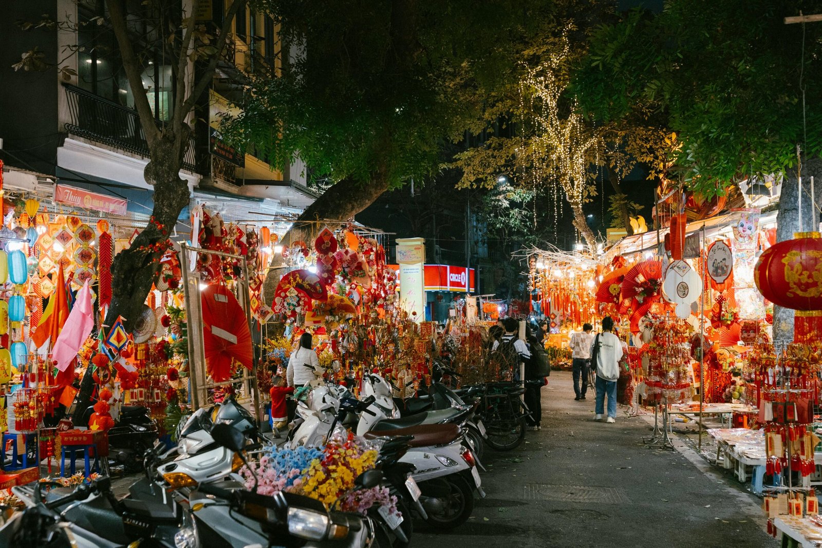 Narrow streets of Hanoi’s Old Quarter filled with motorbikes and traditional shops.