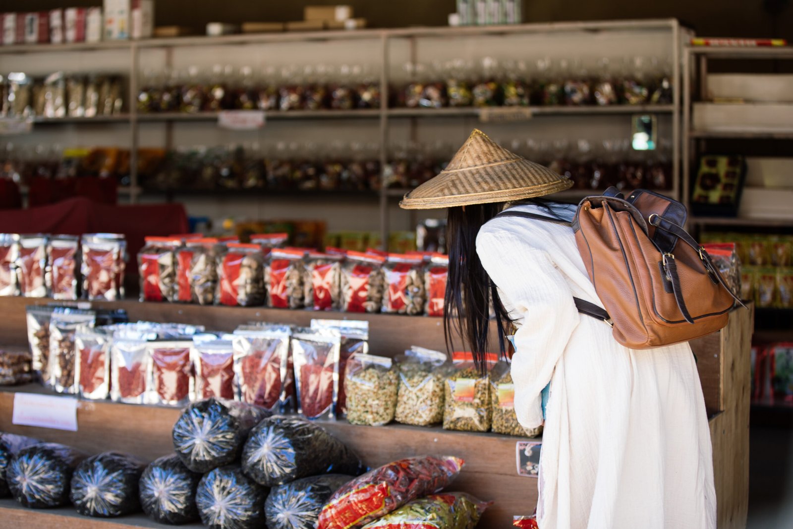 A traveler shopping at a vibrant Southeast Asia market, immersed in local culture.