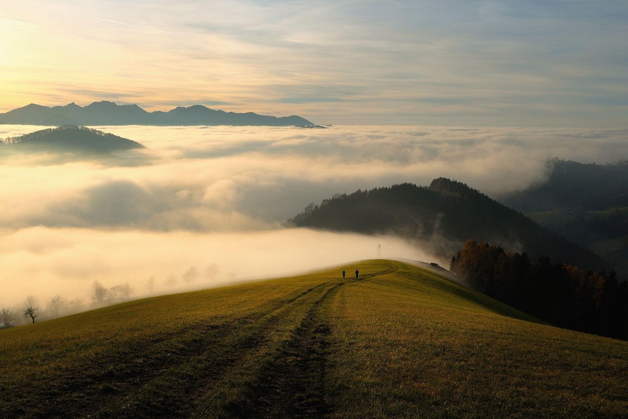 A breathtaking view of a misty European mountain range, inviting adventurers to explore hidden trails.