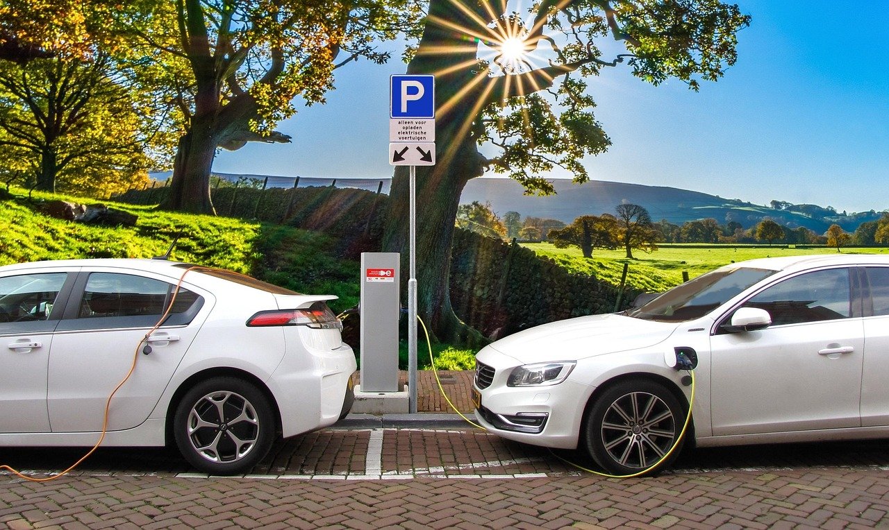 Electric car charging near a scenic viewpoint.