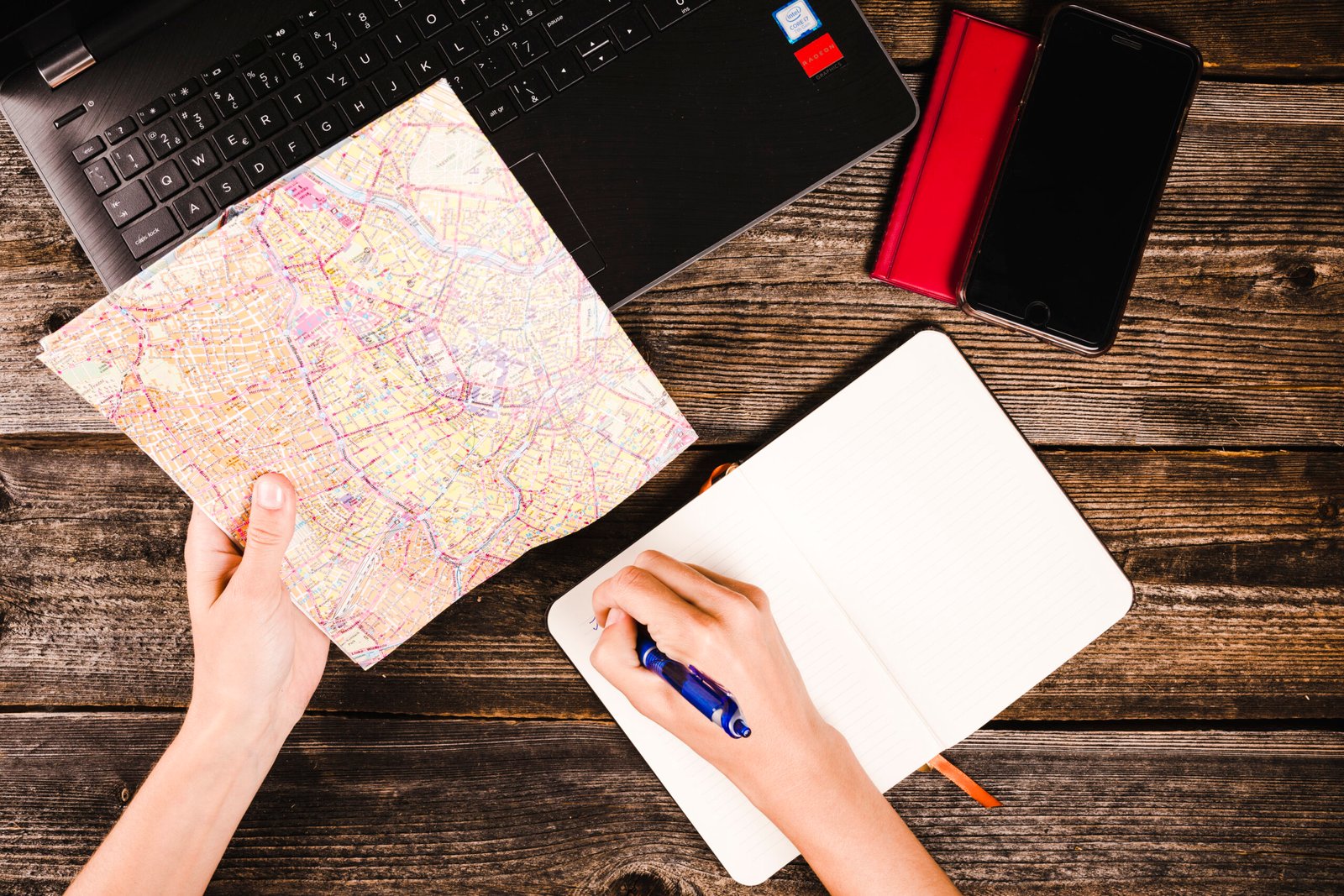 A travel planner with maps, a calculator, and a passport on a desk, ready for budgeting.