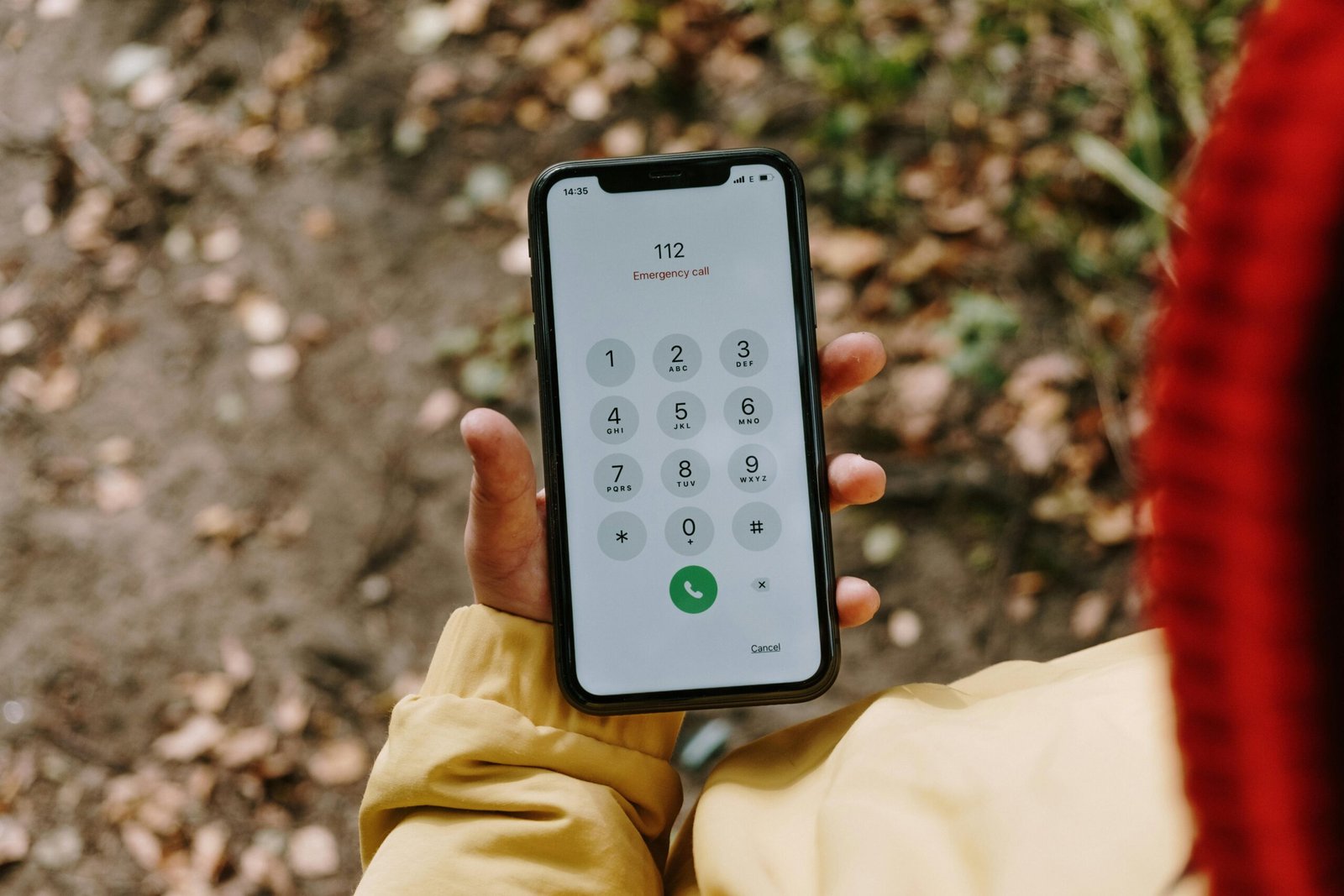 A traveler with a phone and emergency contact list in hand, ready for action.