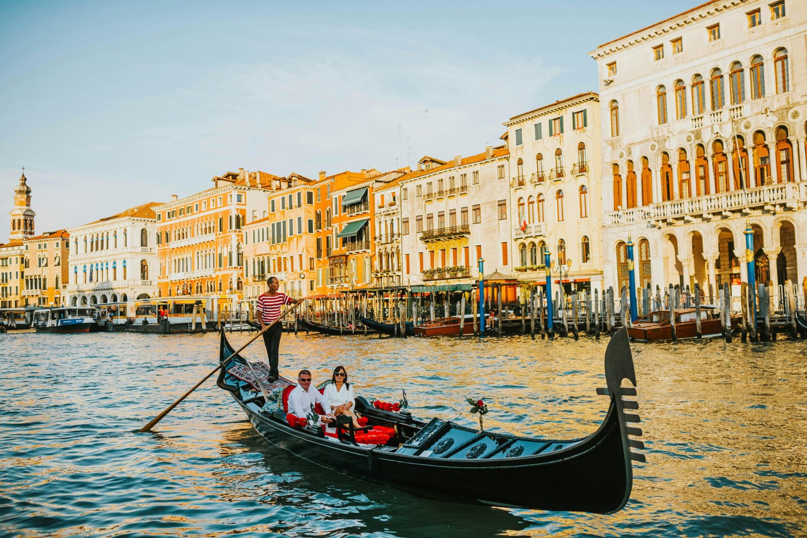 Experience a tranquil gondola ride along Venice's iconic Grand Canal at sunset.