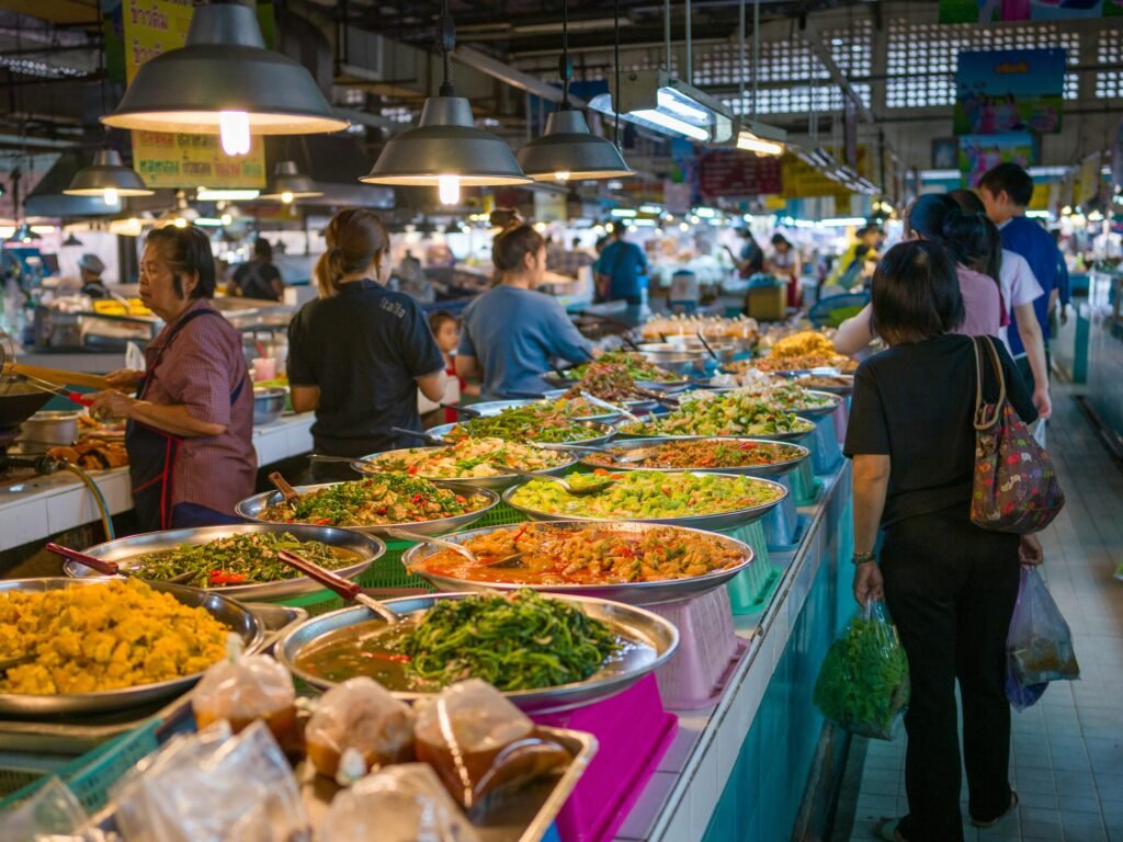 Explore the bustling atmosphere of a Bangkok street market with colorful Thai cuisine.