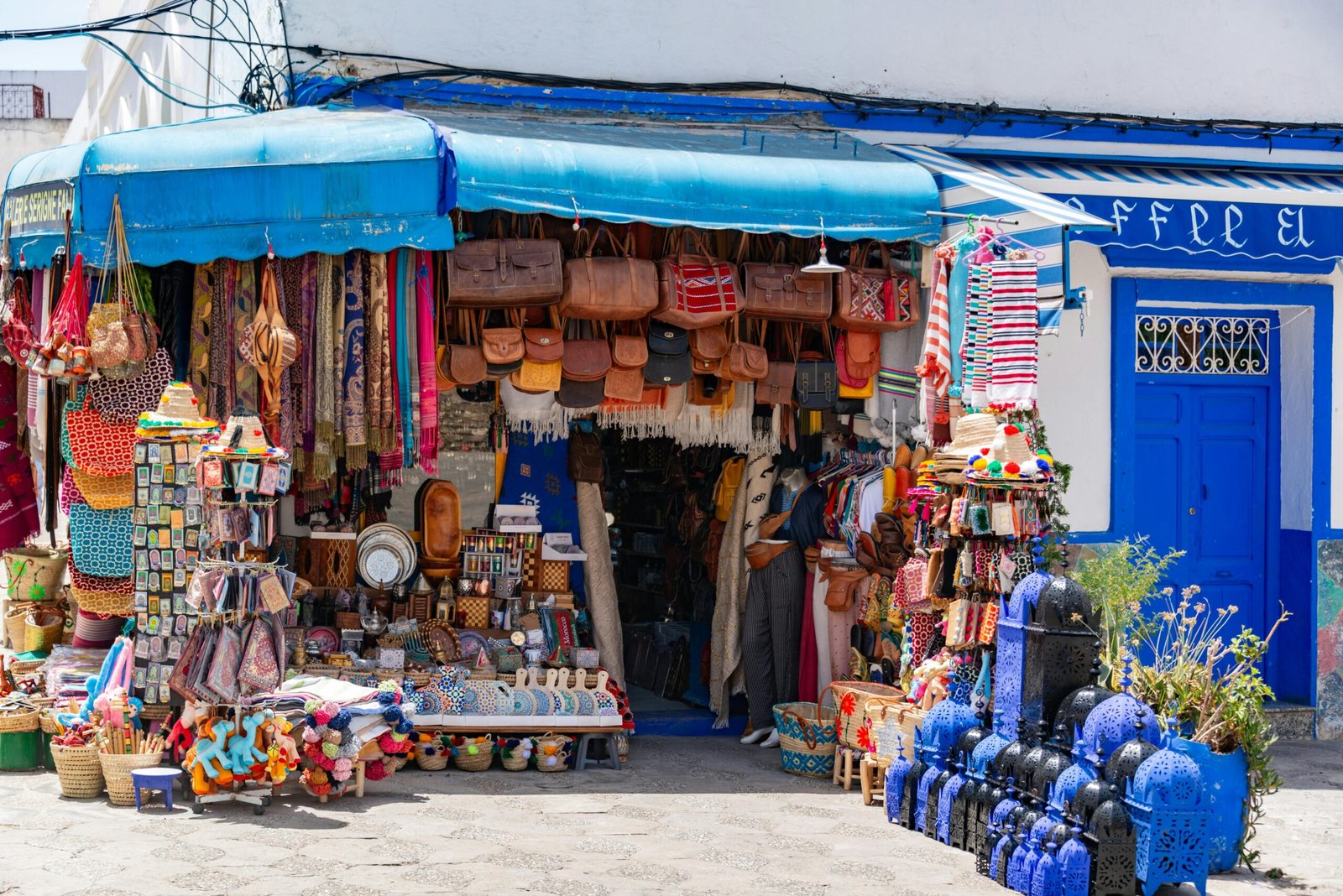 Vibrant market stall showcasing various handmade goods in a bustling Tunisian street.