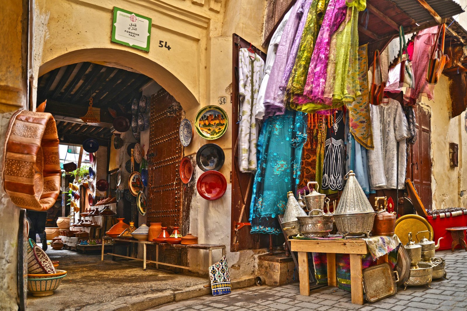 A vibrant African market with colorful textiles and traditional crafts on display.