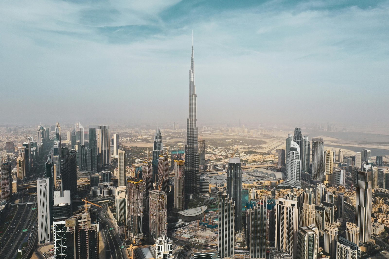 The Burj Khalifa in Dubai, towering over the city skyline at dusk, showcasing the UAE’s modern allure.