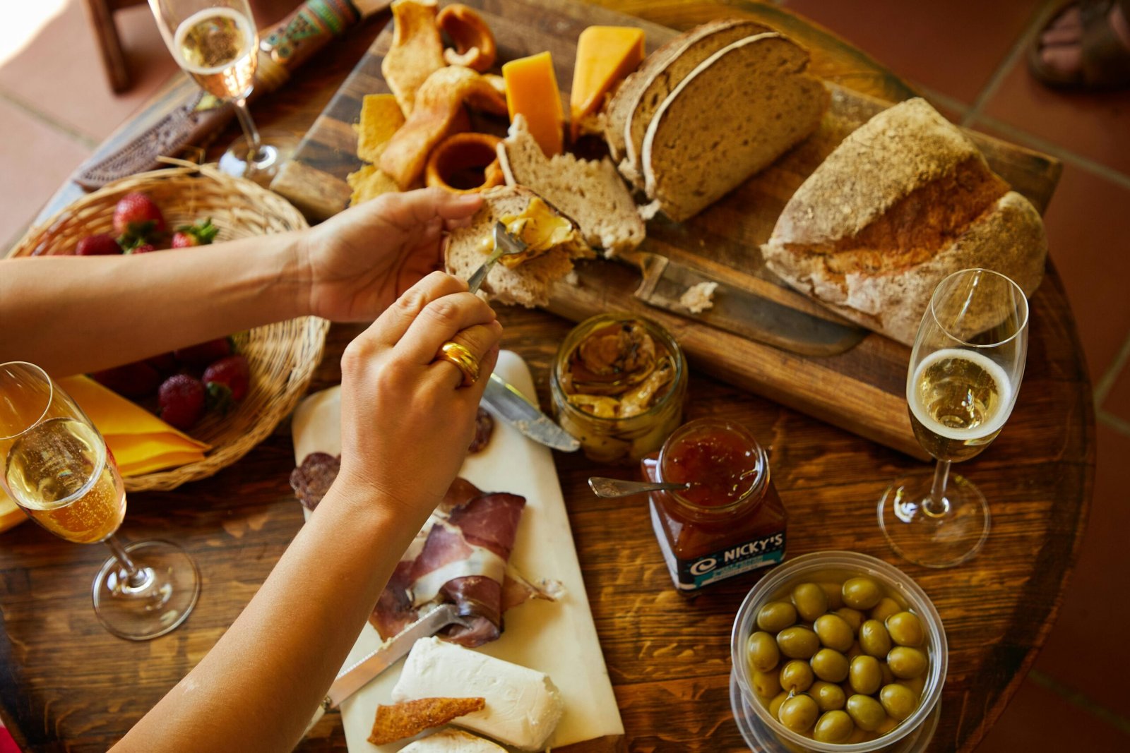 Elegant charcuterie board with breads, cheeses, olives, and champagne for a perfect gathering.