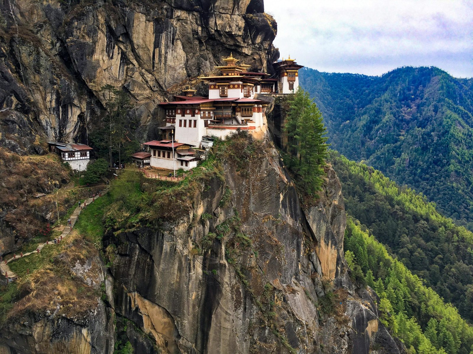 The Tiger’s Nest Monastery perched on a cliff in Bhutan, surrounded by misty Himalayan peaks.