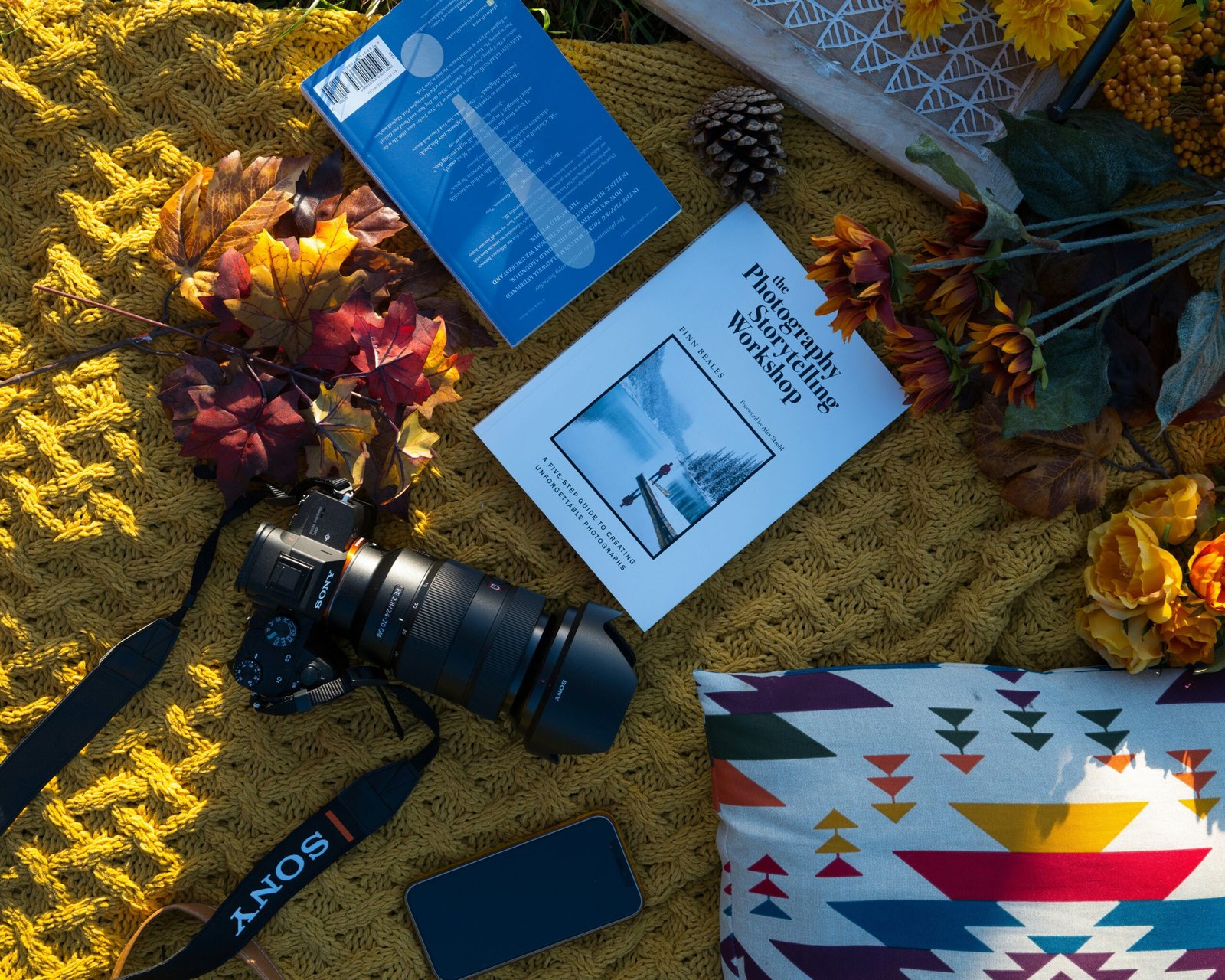 A traveler’s essentials, including a camera, traditional scarf, and guidebook.