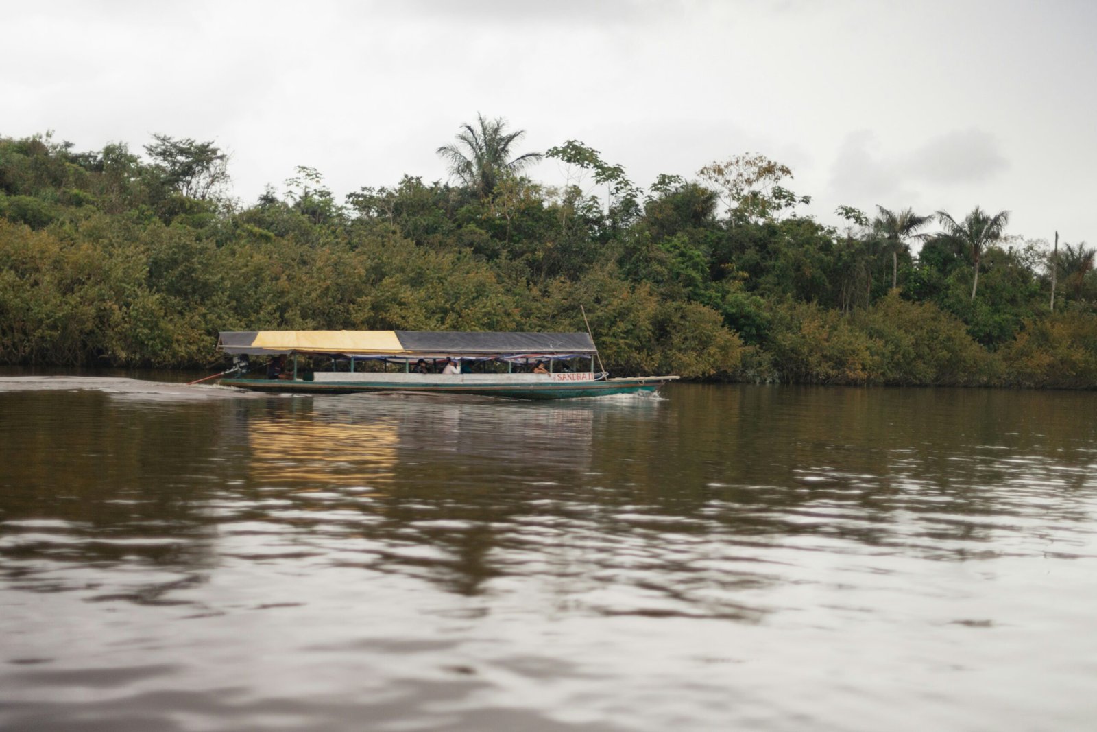 A solar-powered river taxi gliding through the Amazon, symbolizing sustainable summer travel in Brazil.