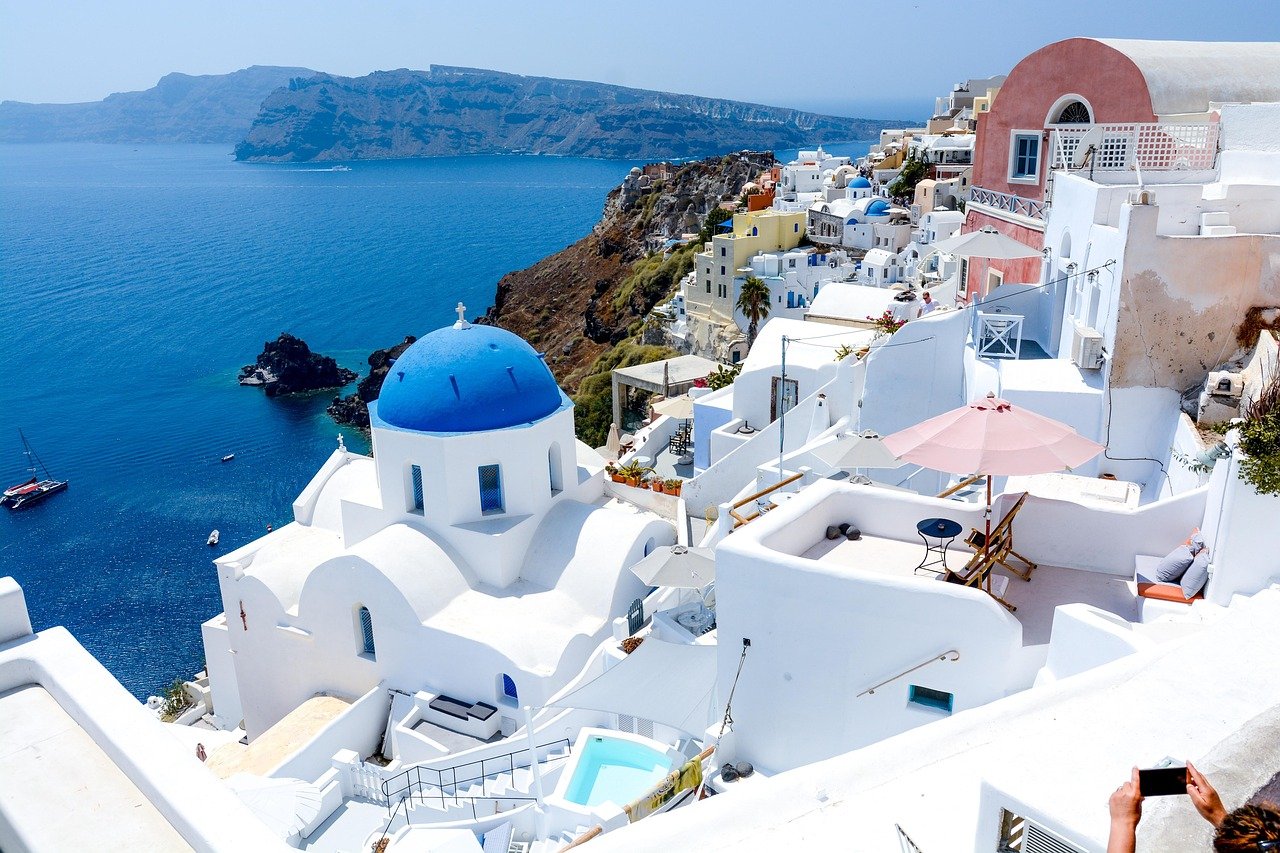 Santorini Oia sunset with blue domes