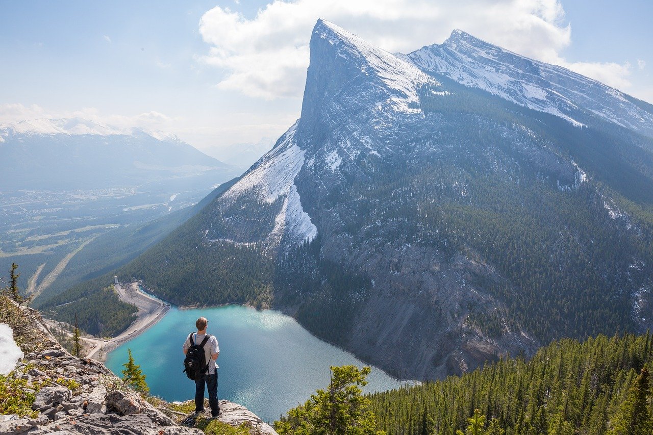 Hiker on mountain trail with panoramic views