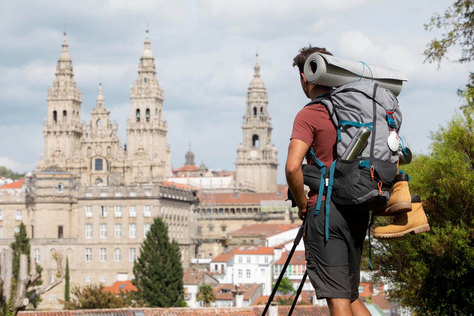 A solo traveler with compact clothing and safety gear, exploring a European summer city.