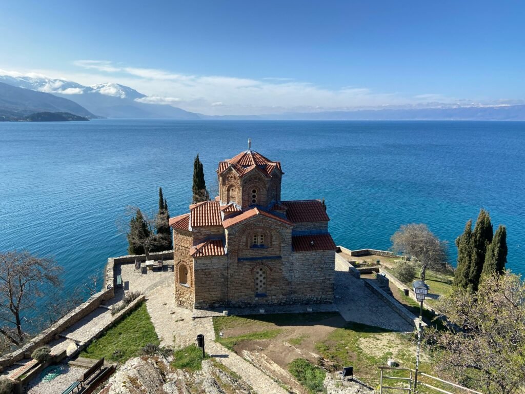 Aerial view of Saint John the Theologian Church by Lake Ohrid, North Macedonia, on a clear day.