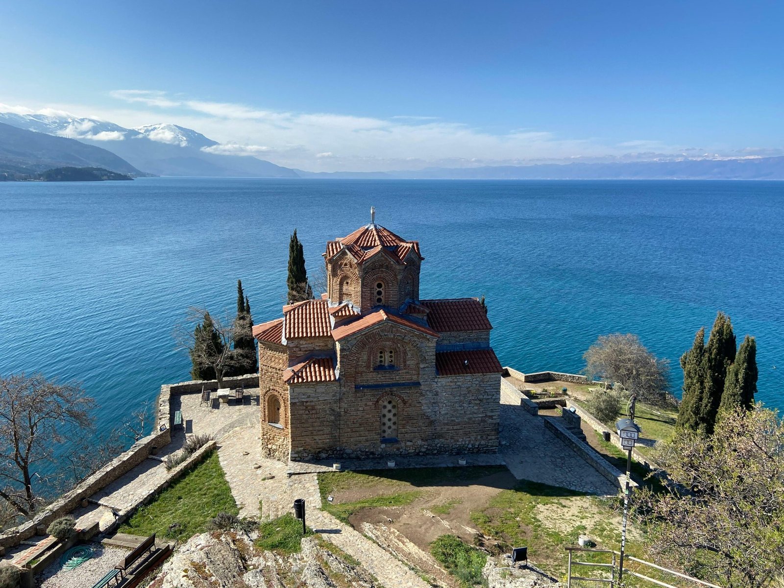 Aerial view of Saint John the Theologian Church by Lake Ohrid, North Macedonia, on a clear day.