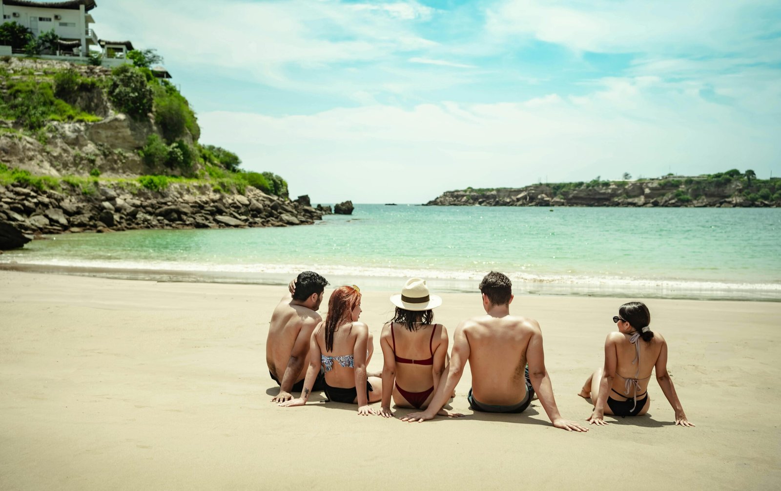 Friends enjoying a sunny beach day in Ecuador, capturing the essence of summer relaxation and coastal beauty.