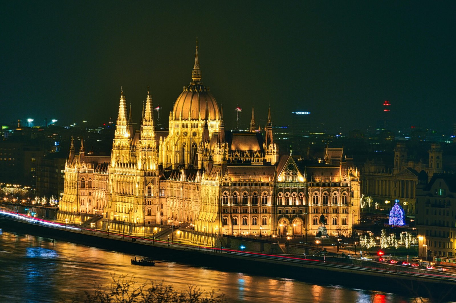 Stunning night view of the illuminated Hungarian Parliament Building reflecting on the Danube River in Budapest.