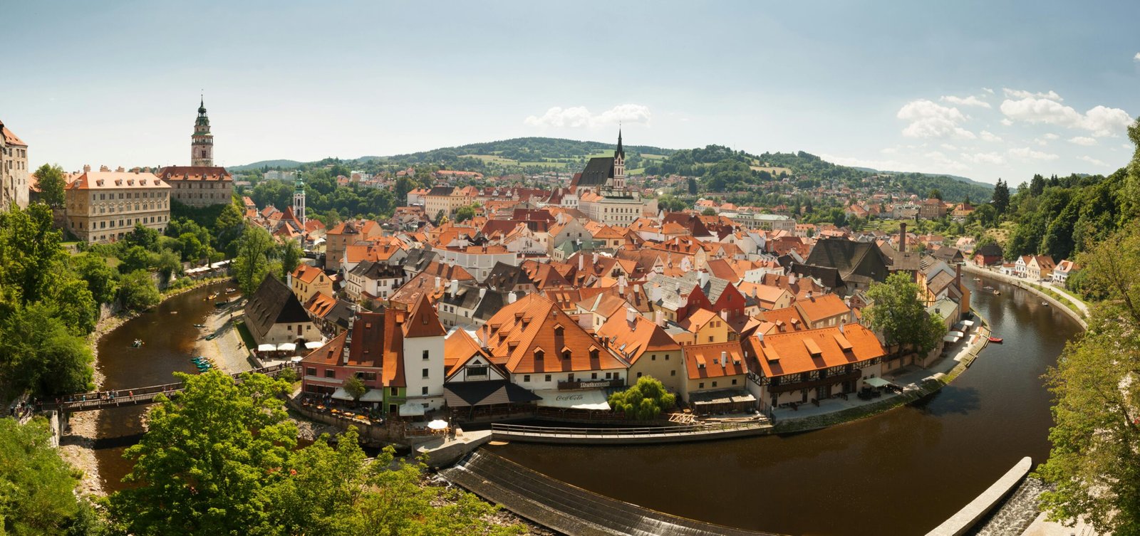 Explore the picturesque Český Krumlov with its red-roofed medieval buildings and winding Vltava River.