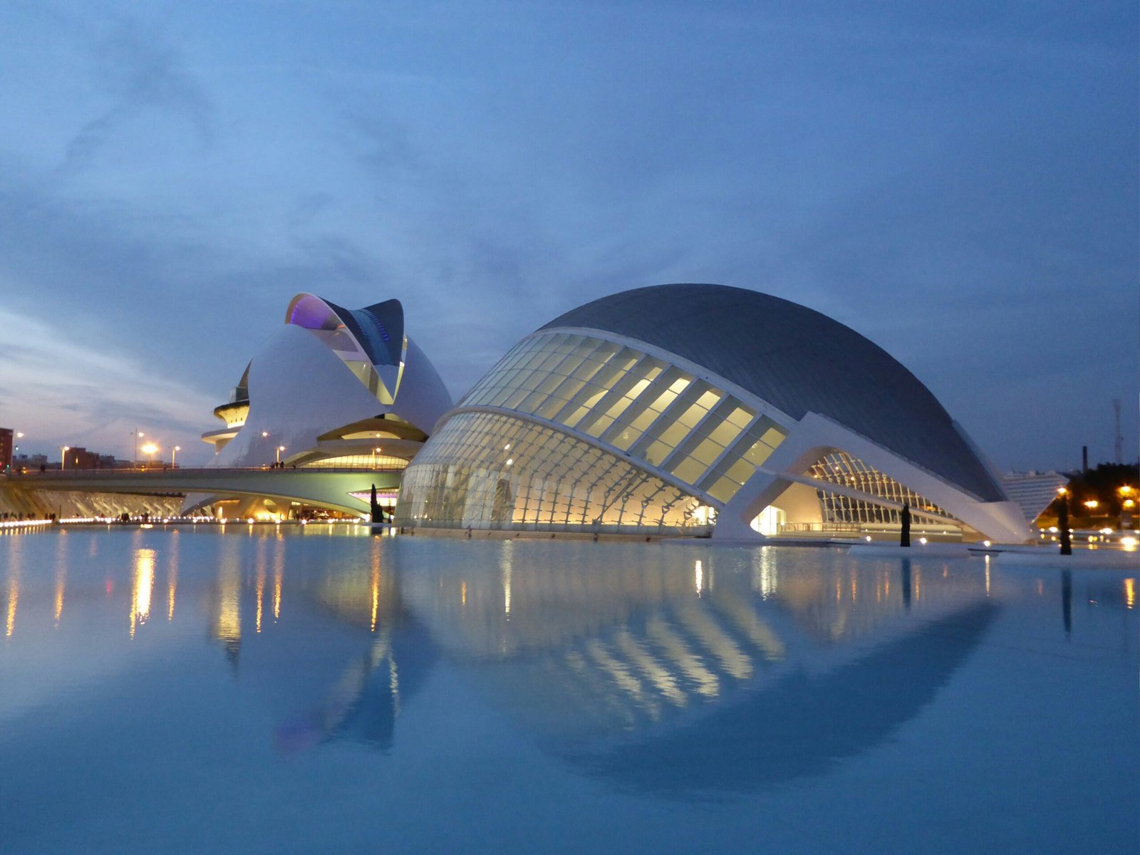 The futuristic City of Arts and Sciences complex in Valencia, Spain, reflecting in the clear blue water pools that surround it.