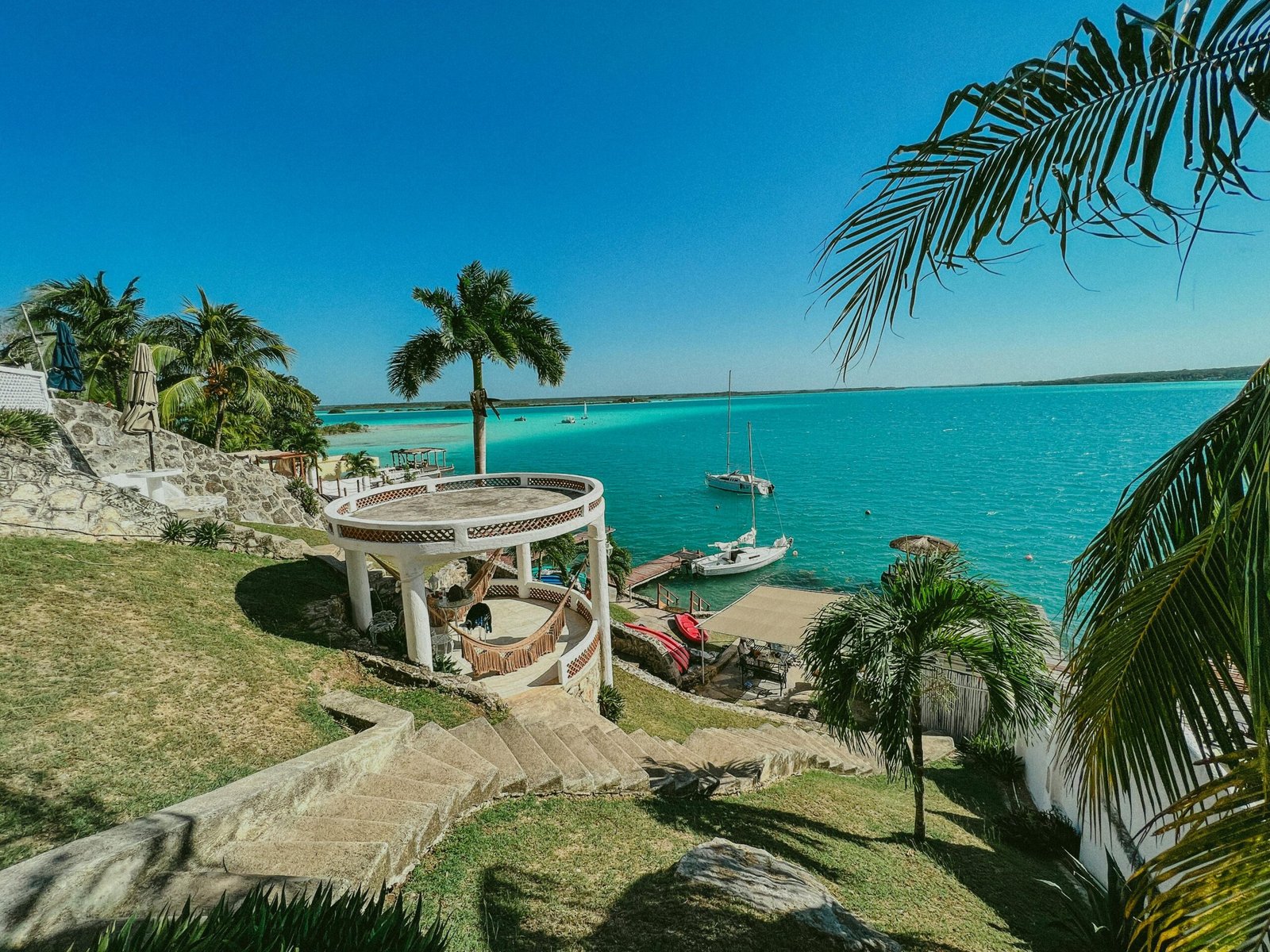 The stunning blue waters of Bacalar Lagoon with traditional Mexican boats