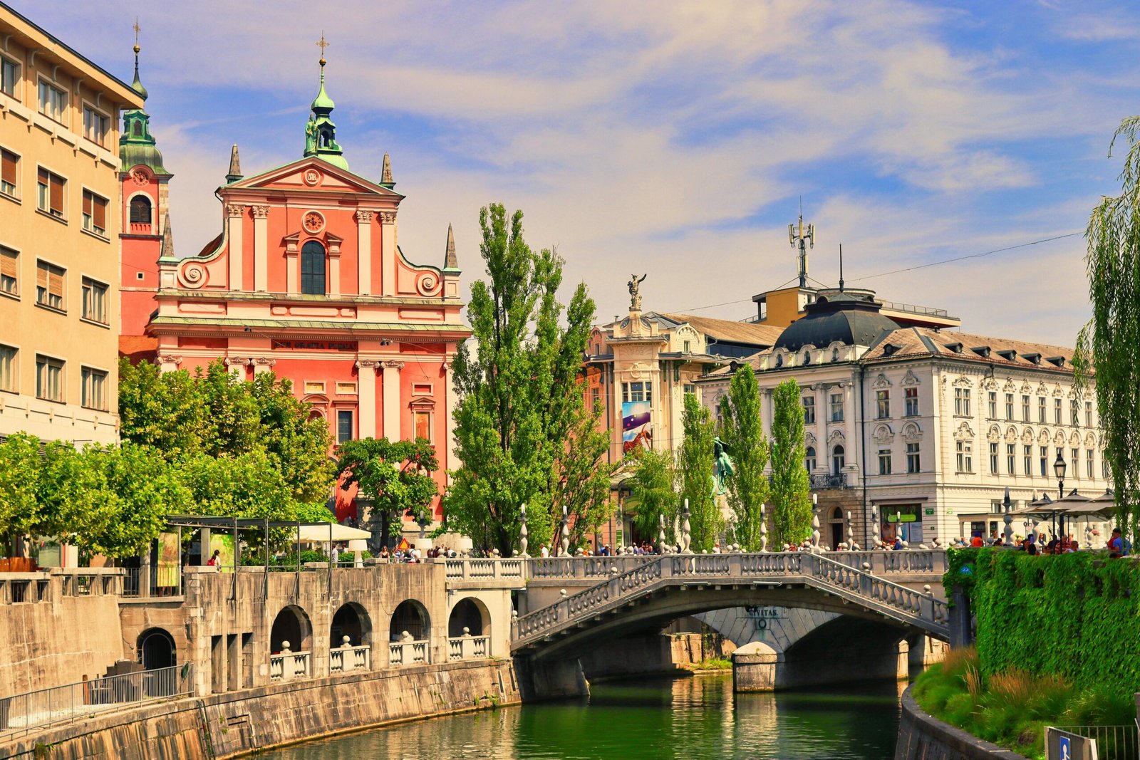 A beautiful shot of Ljubljana's Triple Bridge and colorful buildings along the river