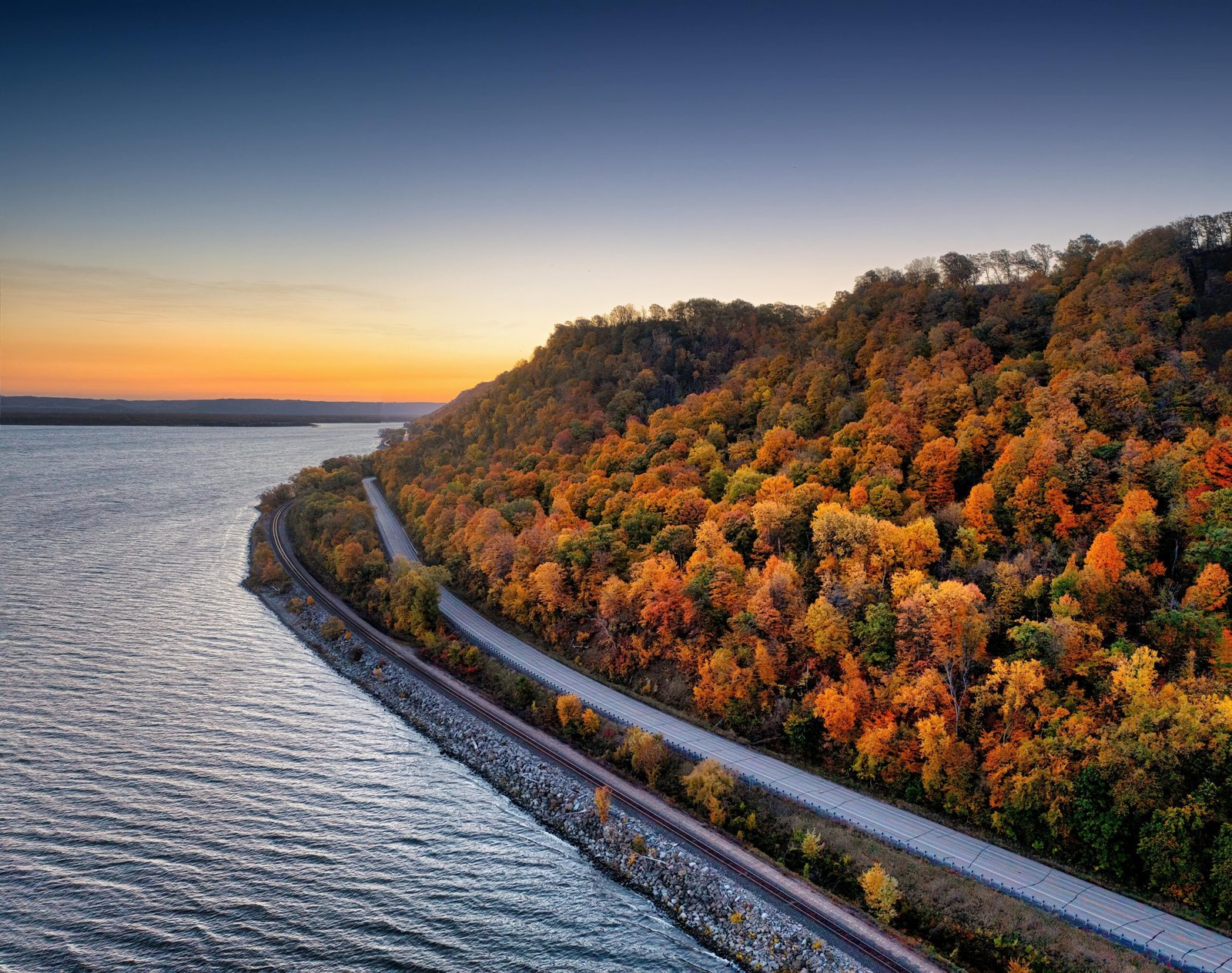 Scenic autumn colors along a winding road by Maple Springs, Minnesota at sunset.