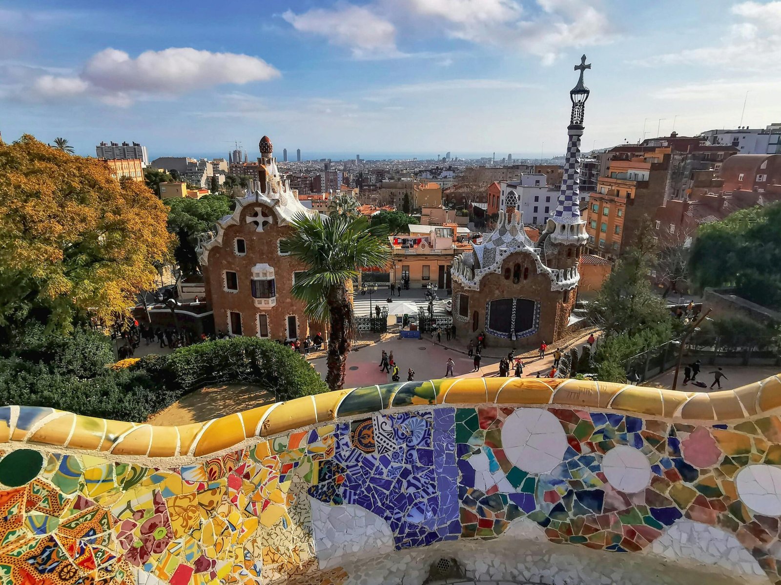 A colorful mosaic and architectural view of Park Güell in Barcelona, showcasing Gaudí's unique style.