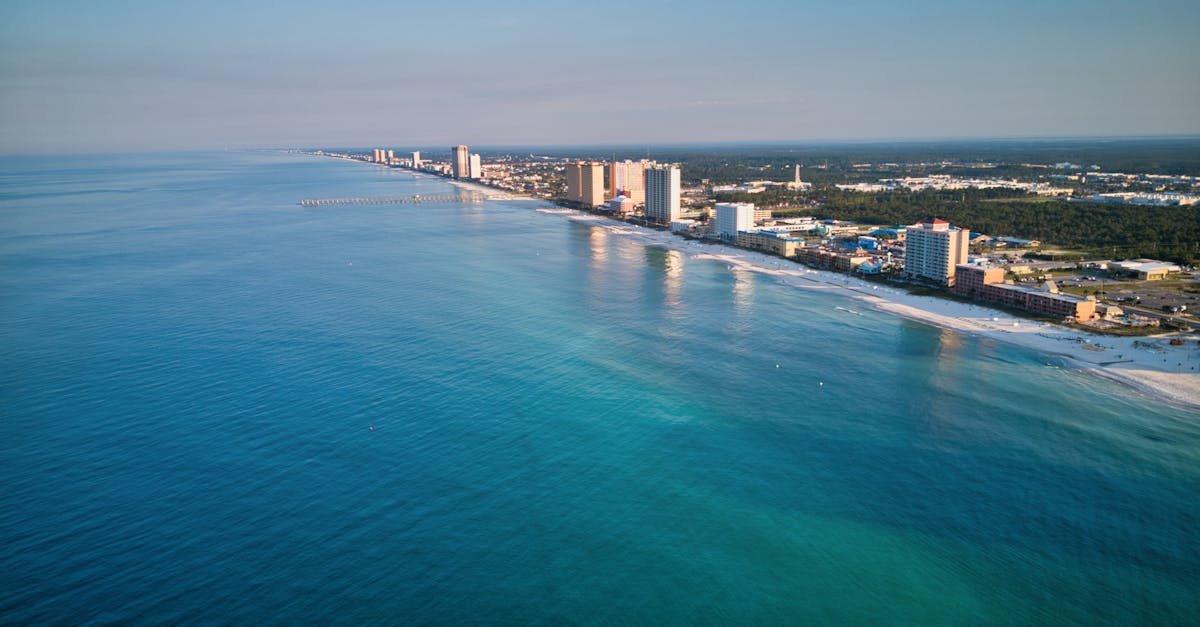 Stunning aerial view of Panama City Beach's coastline with clear blue waters and skyscrapers in view.